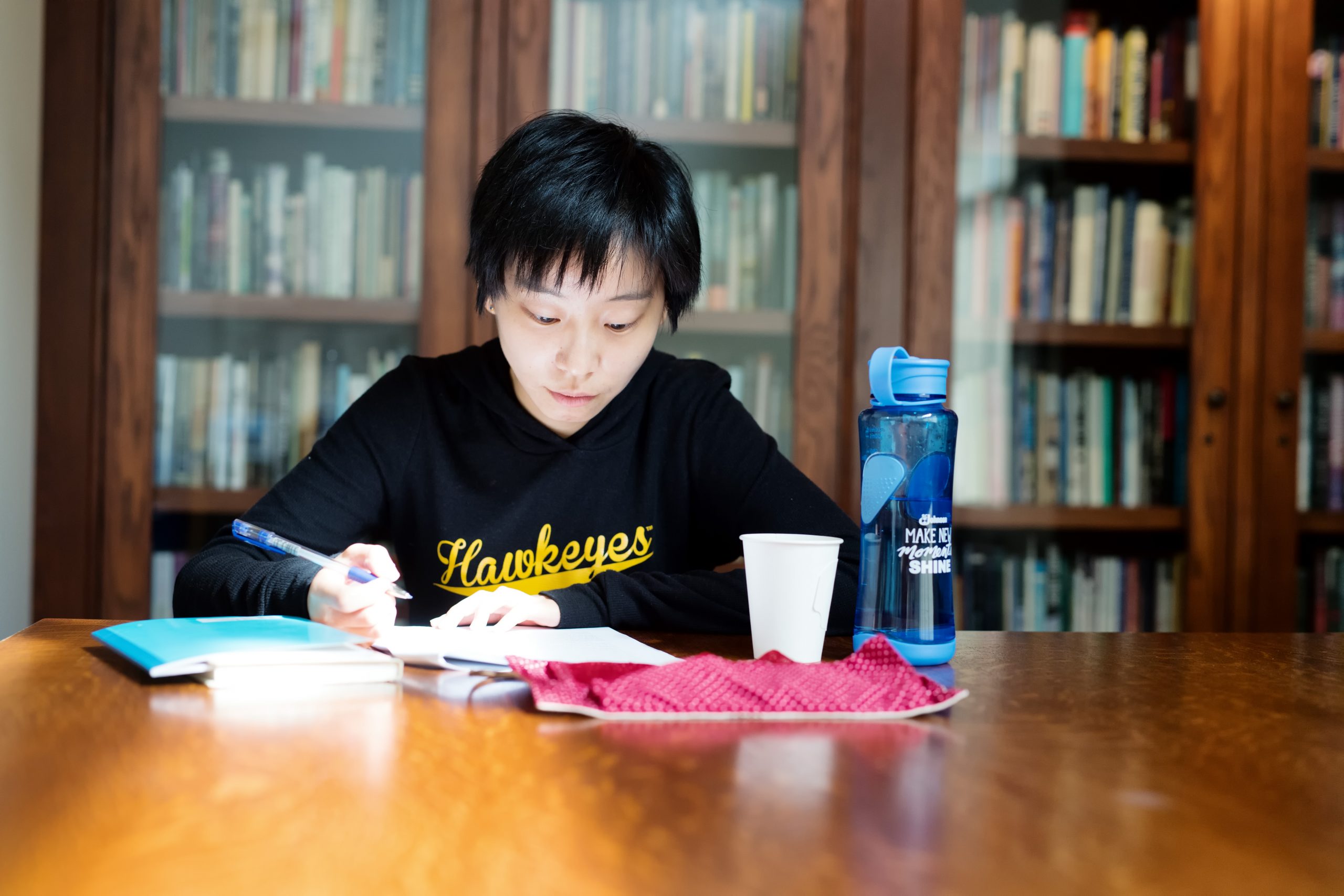 A student studying at a table in the Dey House.