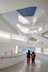 Two students walking through the Visual Arts Building.