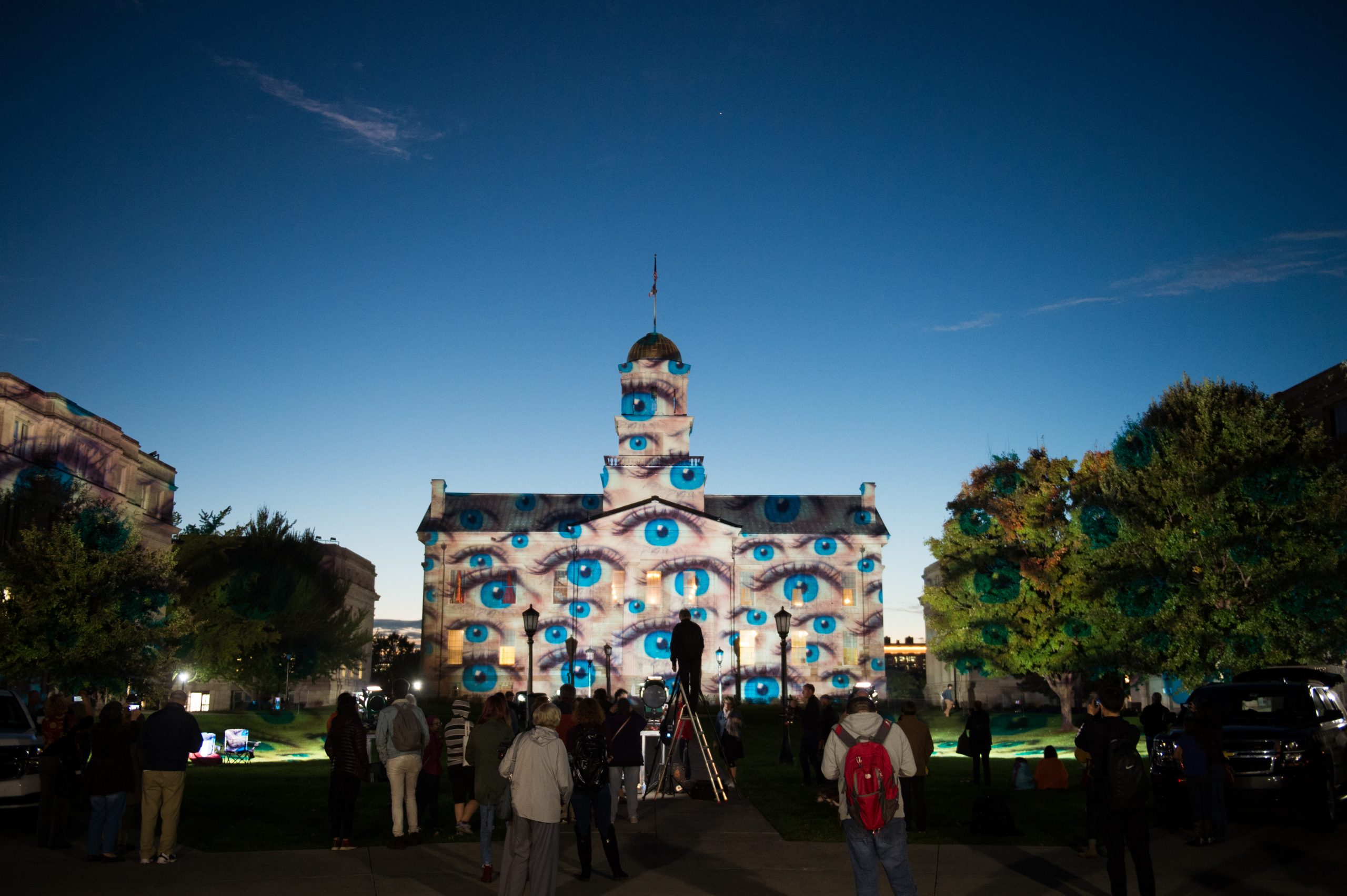 Blue eyes projected onto the Old Capitol as part of a light show by light artist Gerry Hofstetter.