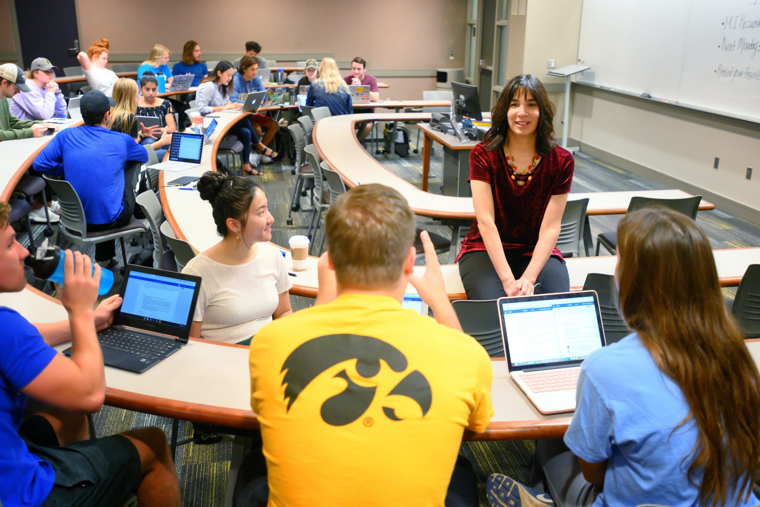 Associate Professor of Practice Peggy Stover interacting with a group of students in a marketing class in the Pappajohn Business Building.