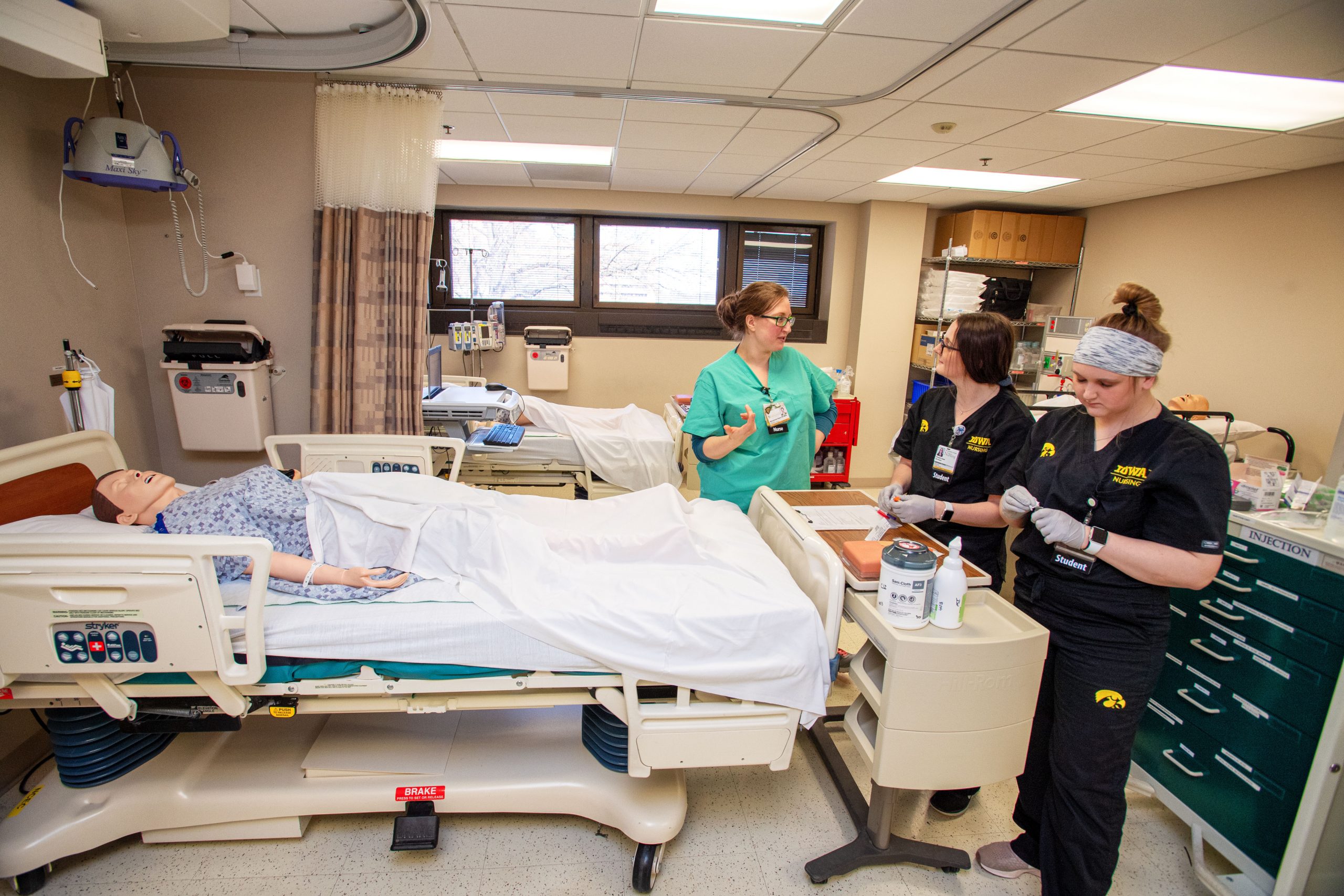 Nursing students Regan Hulsing and Michaela Inman in a simulated hospital room in the Clinical Education Center.