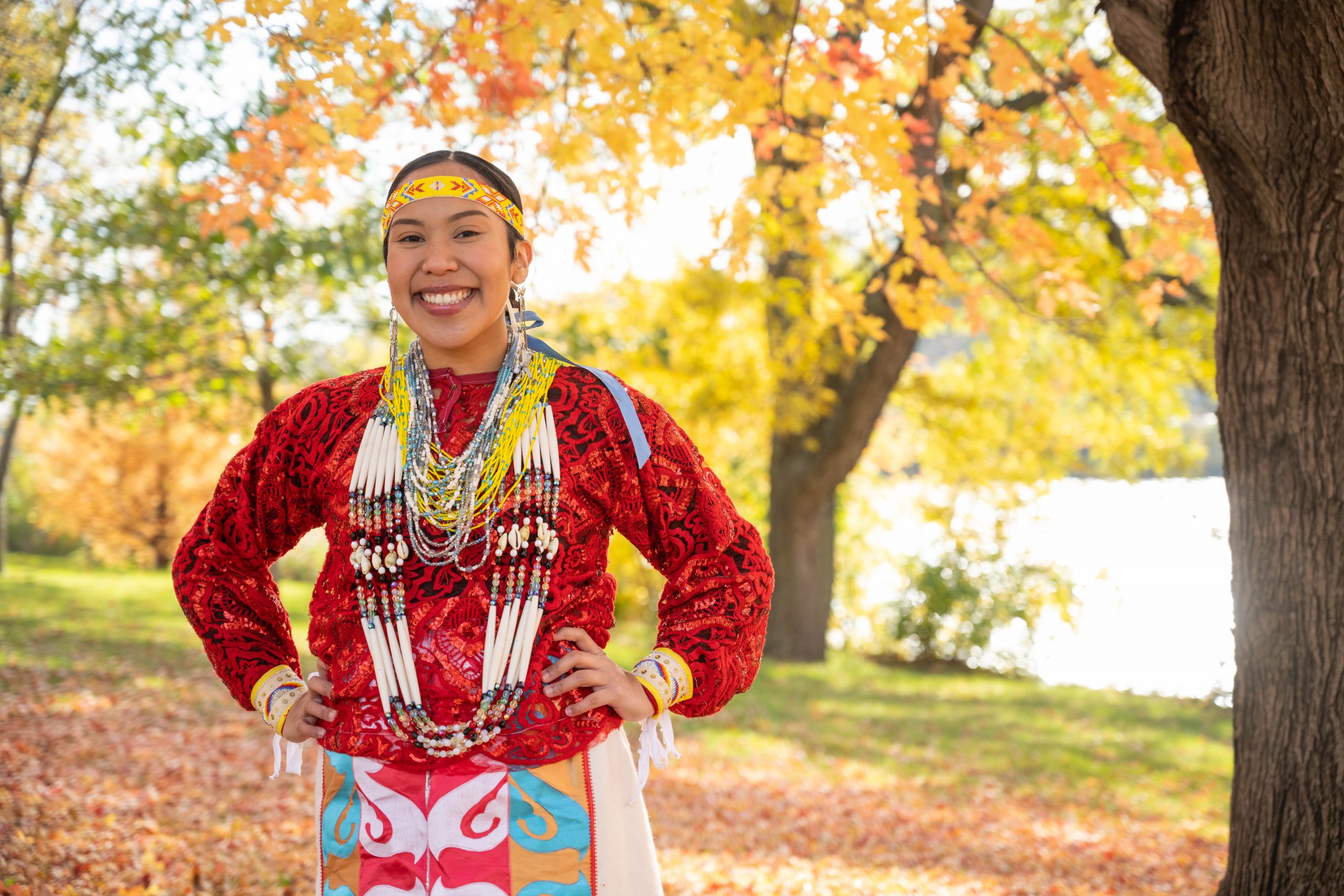 Portrait of student Queta Wanatee-Diego in front of fall foliage.