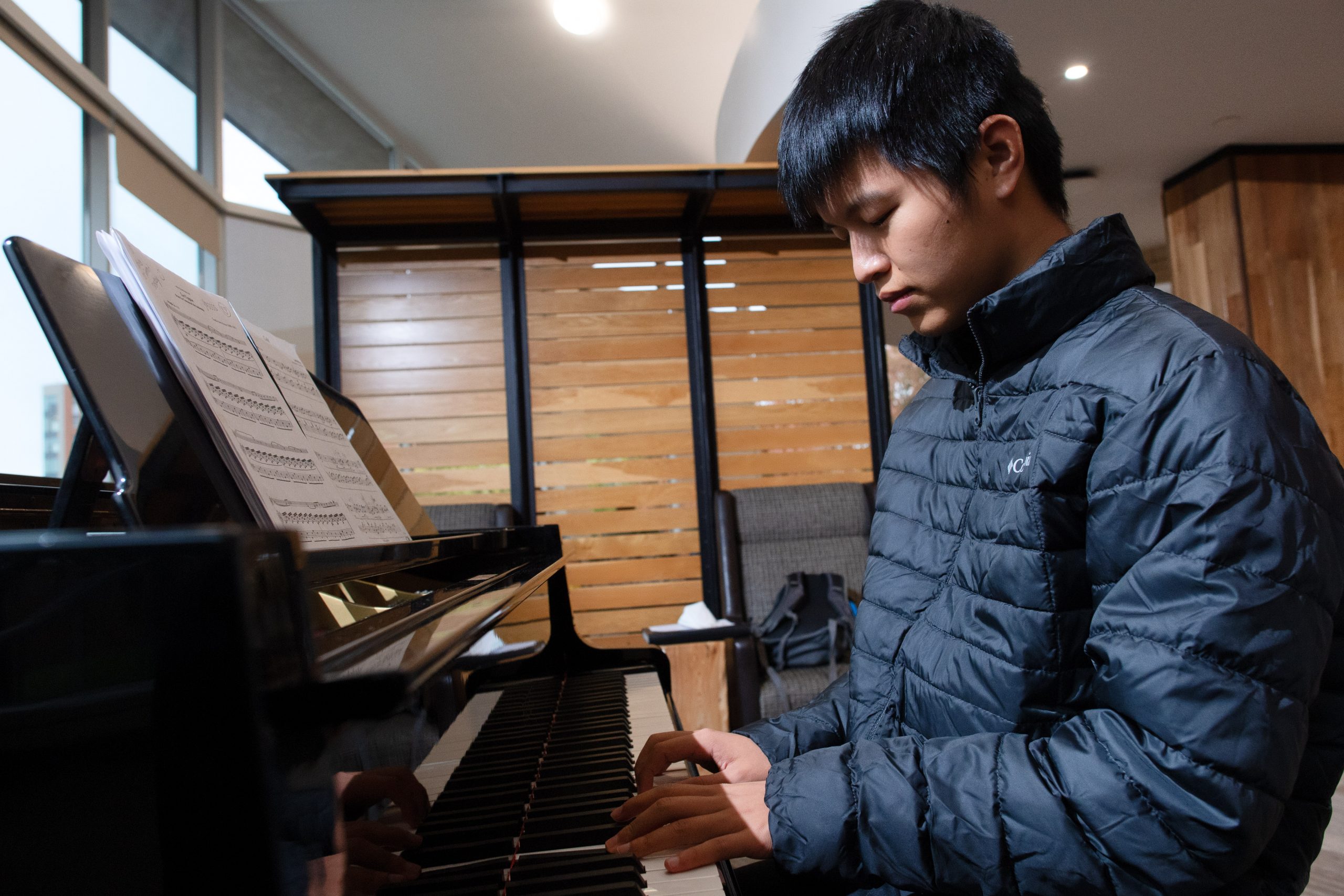 A student practicing the piano.