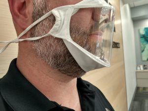 BendShape Mask white male wearing mask that is closed on sides but open over the entire front.