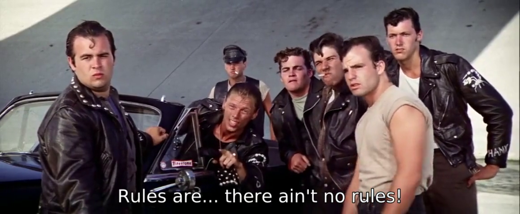 Tough guys standing around a car, preparing for a street race. The subtitle reads, "Rules are ... there ain't no rules!"