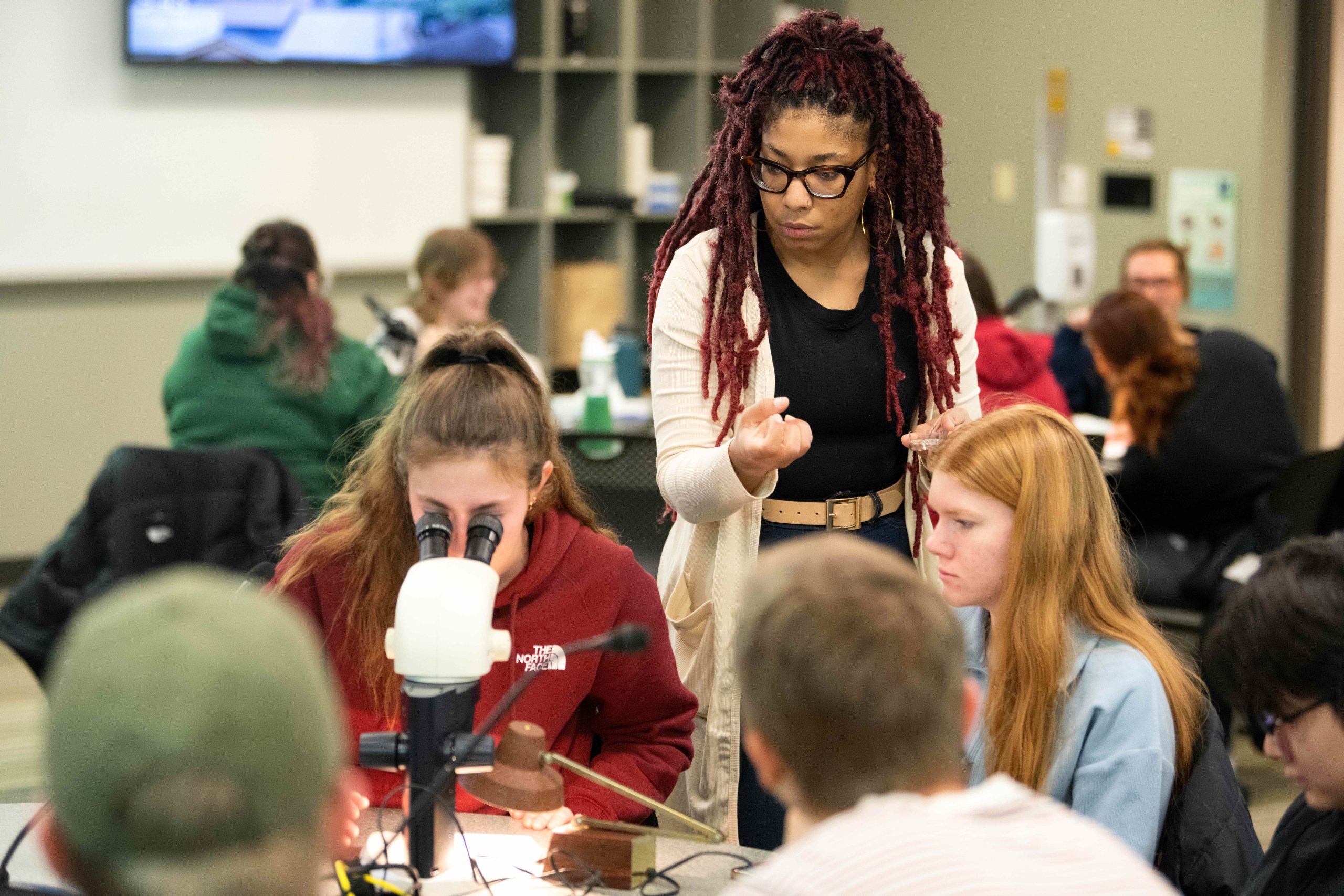 Professor checking in on small groups of students