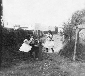 A group of children playing with a homemade seesaw in Argentina.
