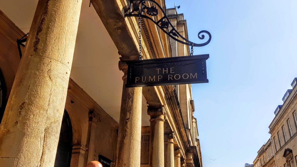 Sign for The Pump Room, a 19th-century tourist attraction in Bath, frequently mentioned in Austen's books