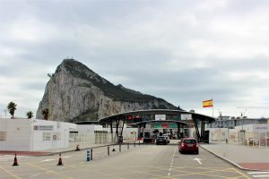 A mountain appears in the background behind a border control