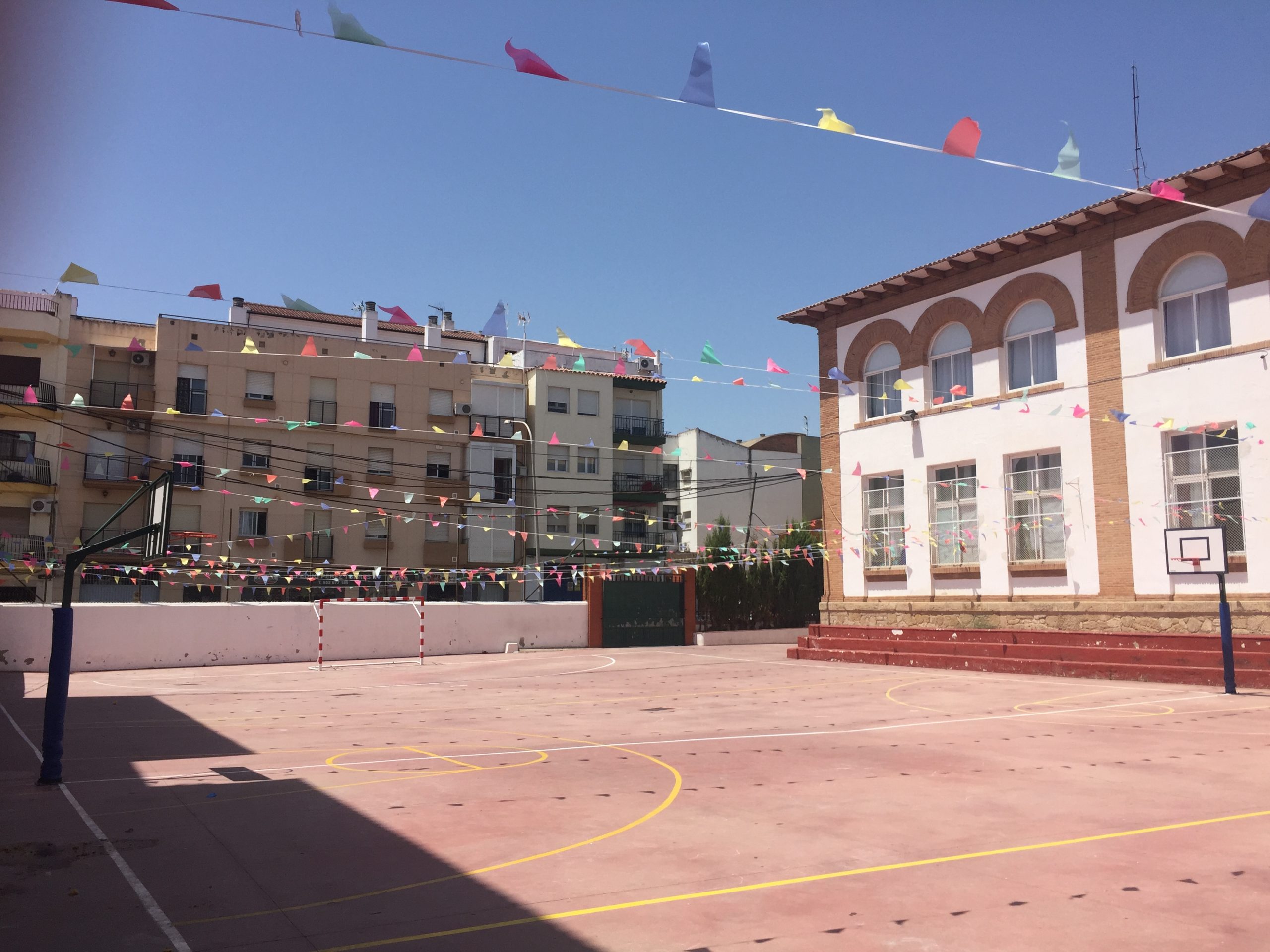 A schoolyard of an elementary school in Spain is decorated with banners