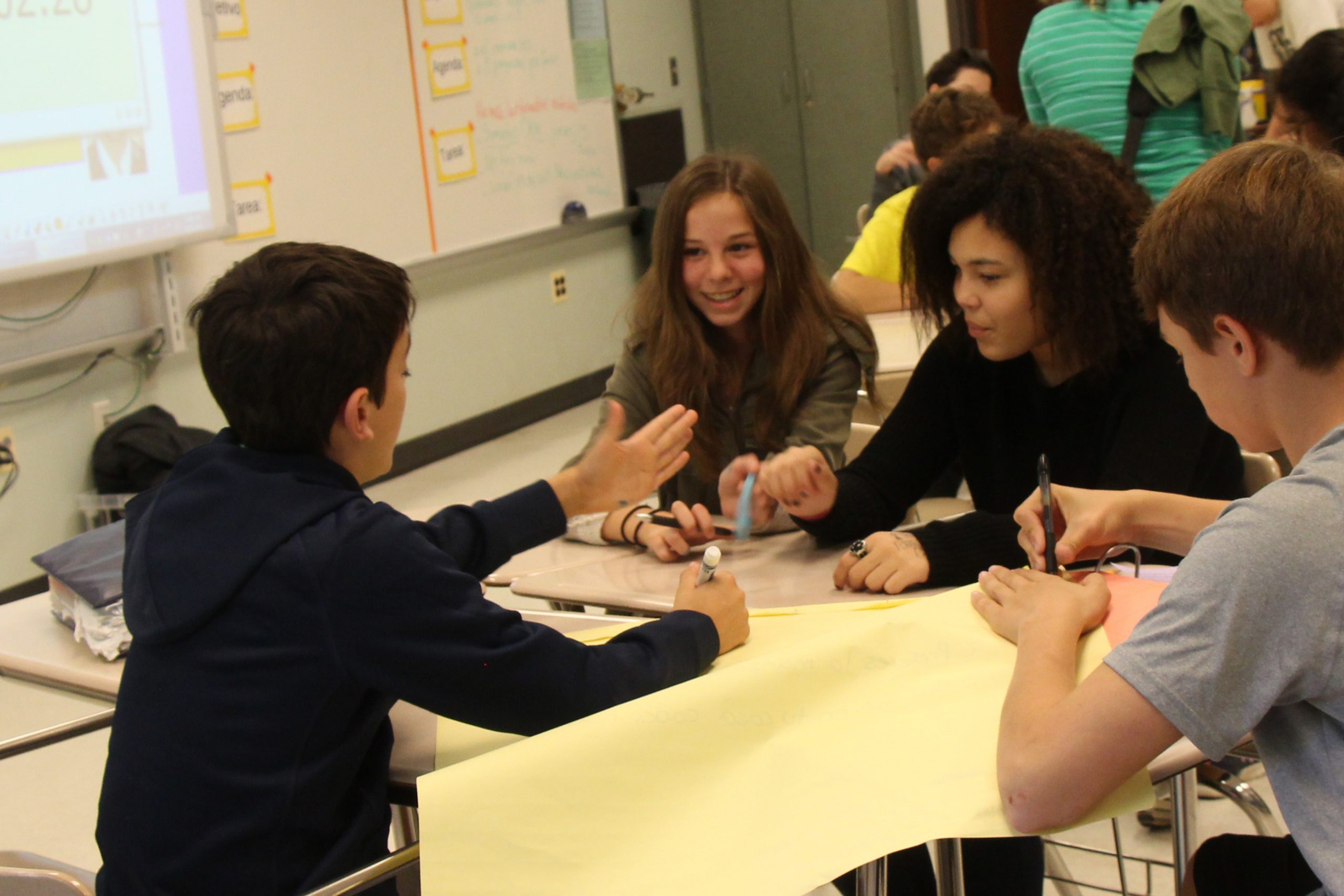 Students work together in a small group during a Spanish class